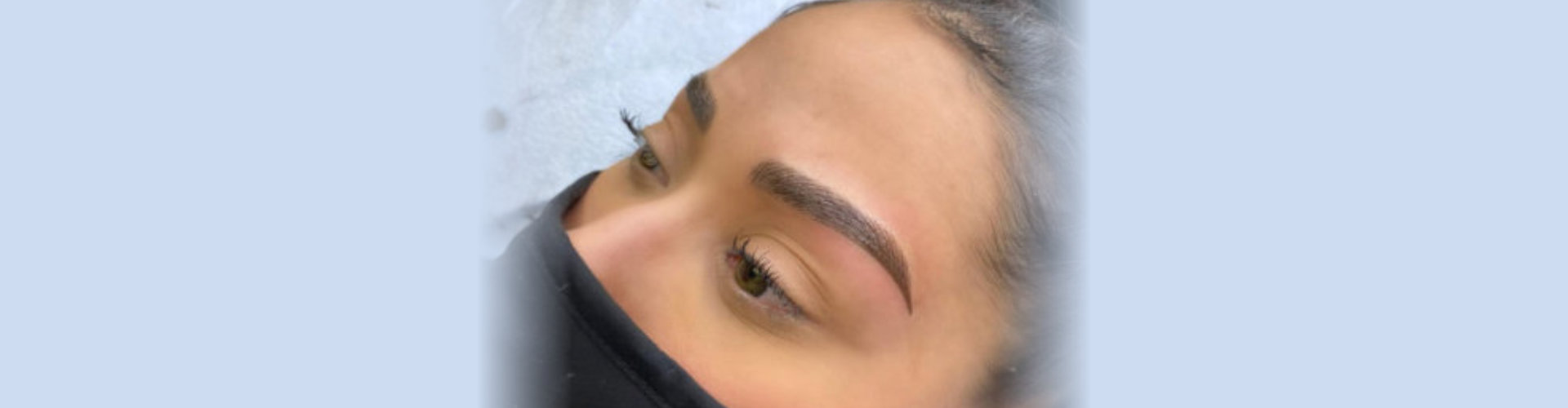 woman getting her eyebrows done