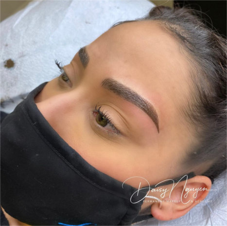 woman getting her eyebrows done